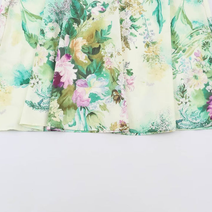 Women’s midi dress with pleated bodice, bell sleeves, and floral A-line skirt