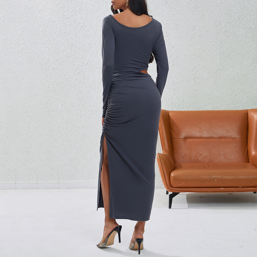 Women's a fitted maxi dress with long sleeves, side cut-out, gathered hip, and high leg slit.