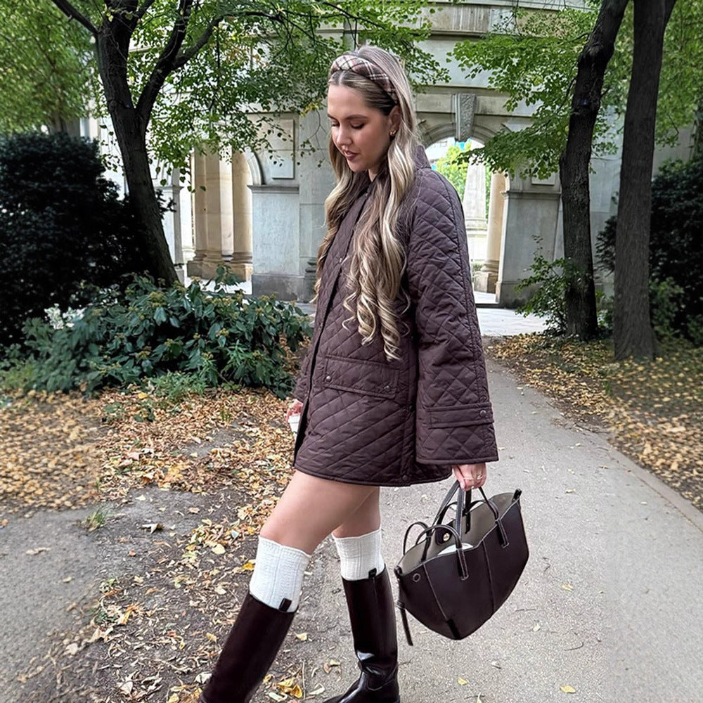Women's oversized quilted jacket in coat style with snap button placket and patch flap pockets Mune Fashion