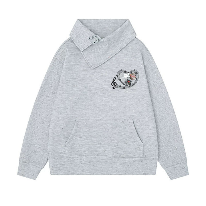 Women’s oversized sweatshirt with asymmetrical stand-up collar, kangaroo pocket and musical heart embroidery Mune Fashion
