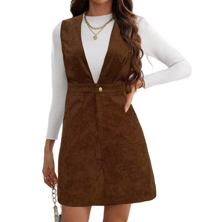 Women's cord overall dress with deep V-neck, waist belt, and A-line design
