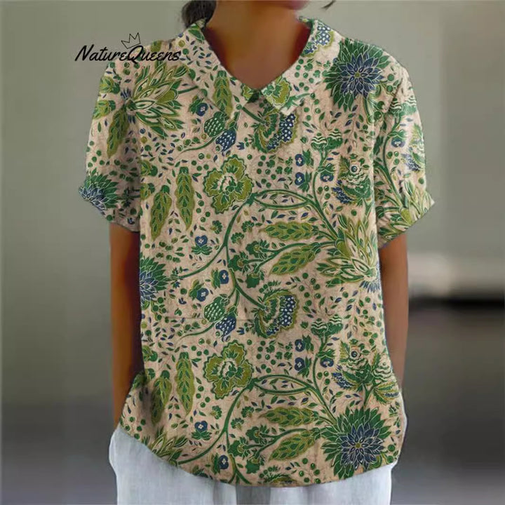 Women's casual short-sleeve blouse with V-neck, rounded hem, and botanical all-over print Mune Fashion