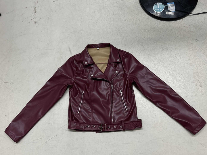 Women's fitted biker jacket made of faux leather with asymmetrical zipper, metallic details, and waist belt Mune Fashion