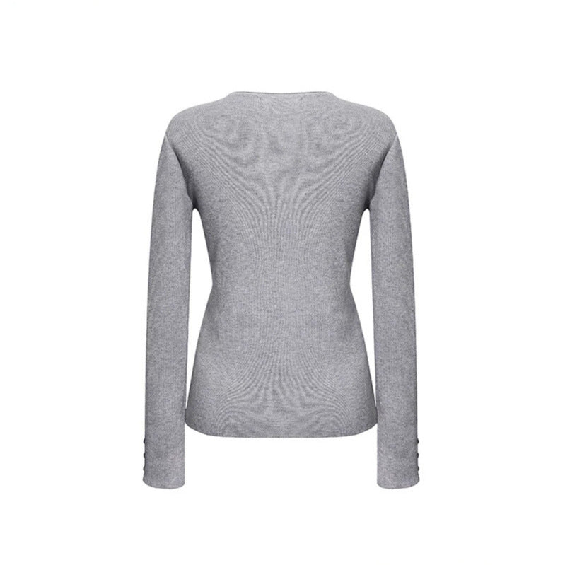 Women's fine knit sweater with round neckline, slim silhouette, and decorative button sleeves Mune Fashion