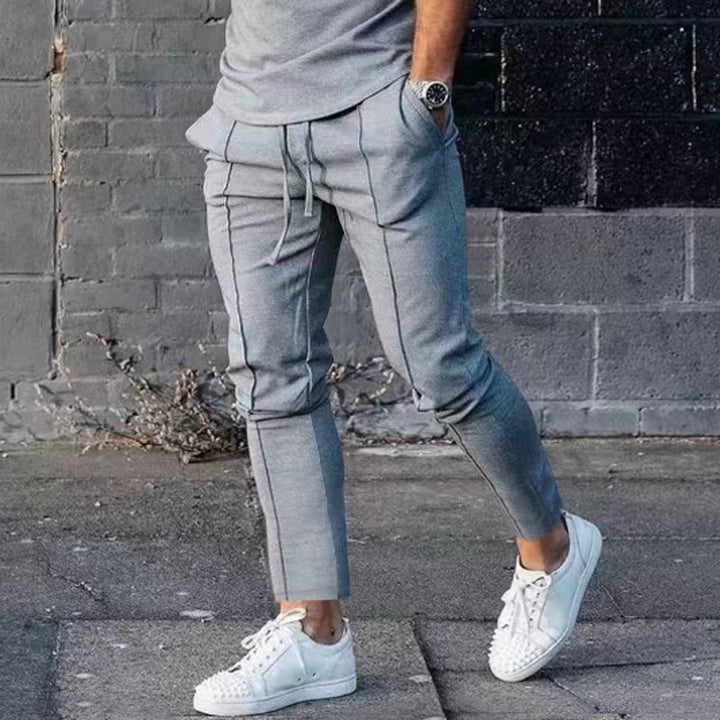 Men's Slim Tapered Jogging Pants with decorative stitching, elastic drawstring, and narrow ankle cuffs Mune Fashion