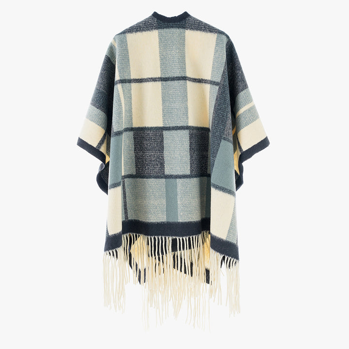 Women's cape poncho in oversized rectangular cut with checkered weave structure and fringes.