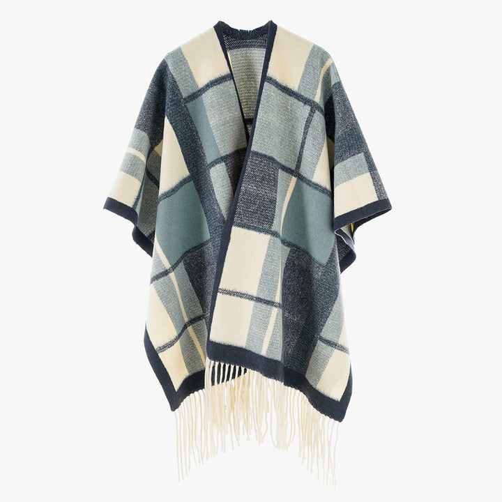 Women's cape poncho in oversized rectangular cut with checkered weave structure and fringes.