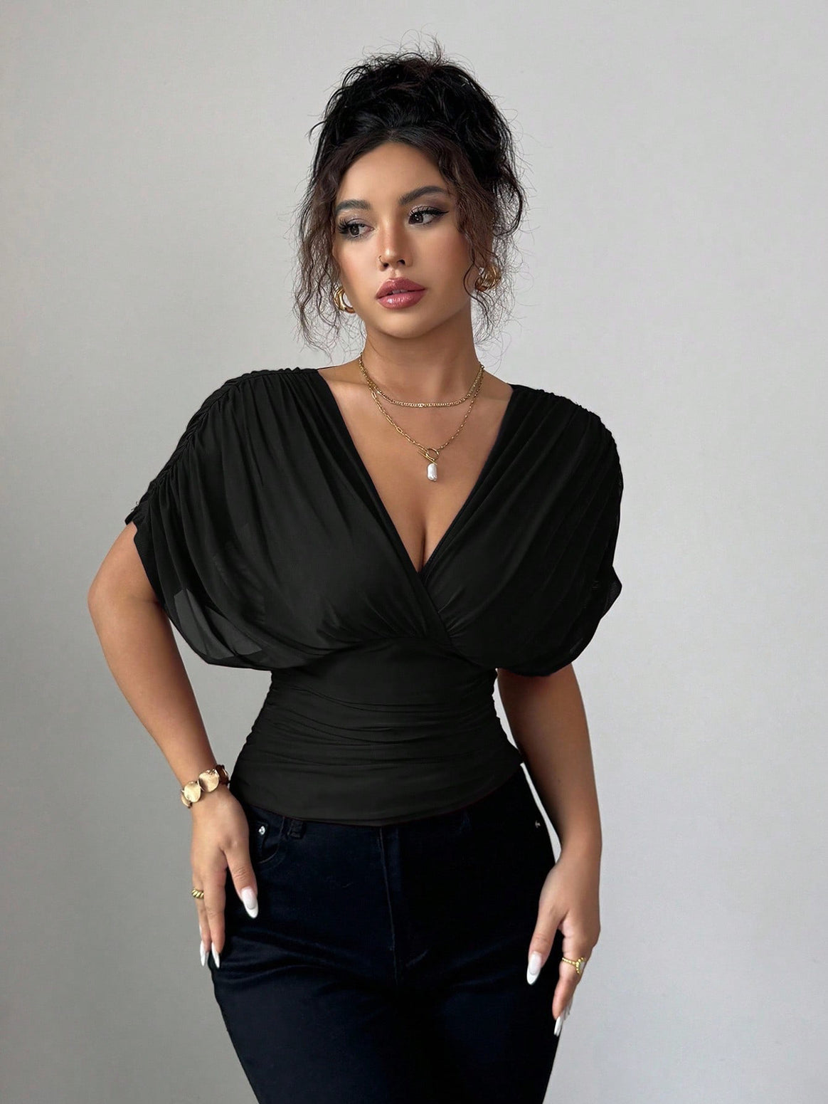 Women's fitted wrap top with deep V-neck and gathered wing sleeves Mune Fashion