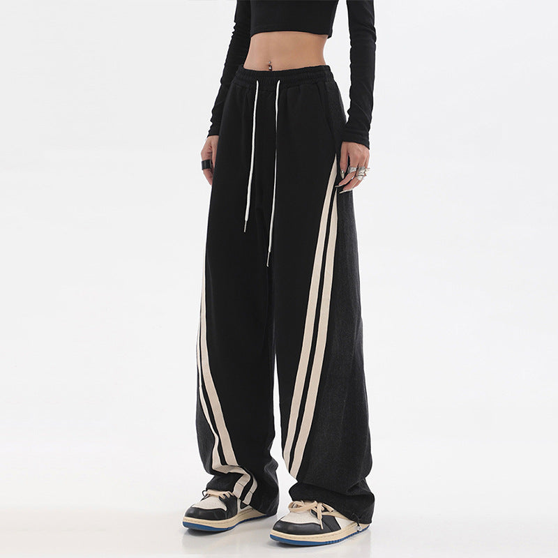 Ladies wide jogging pants with high waist and denim inserts as well as side stripes Mune Fashion