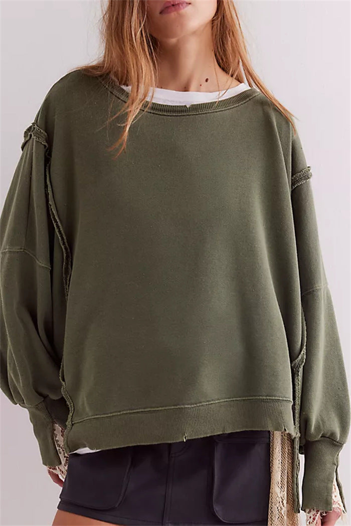 Women's oversized sweatshirt with balloon sleeves, open seam stitches, and side slits Mune Fashion