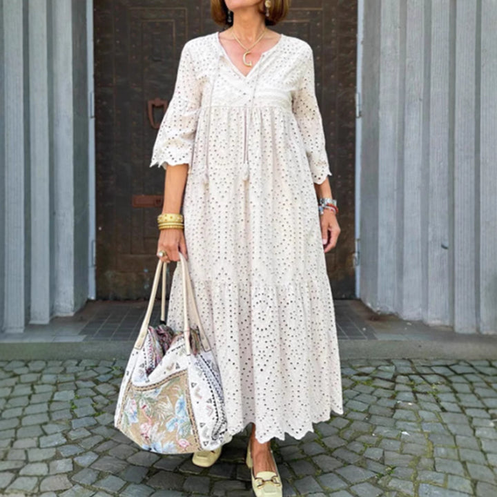Women's flowing maxi dress with openwork embroidery, V-neck, underbust seam, and ruffled skirt Mune Fashion