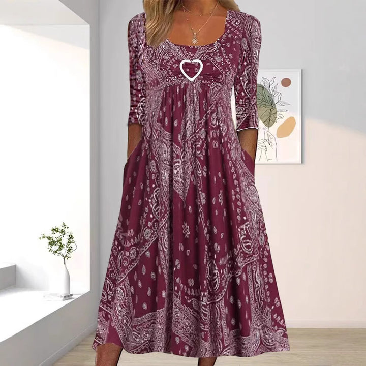 Women's maxi dress with paisley bandana pattern, empire seam, gathered underbust area, and side pockets Mune Fashion