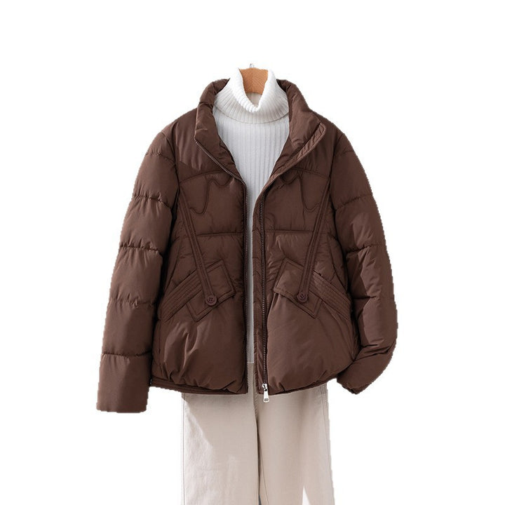 Women's nan short quilted jacket with high collar trim, diagonally placed decorative seams and flap pockets Mune Fashion