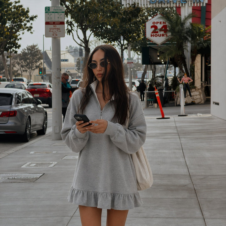 Women's oversized sweat dress with half zipper, balloon sleeves, side pockets, and ruffle hem Mune Fashion