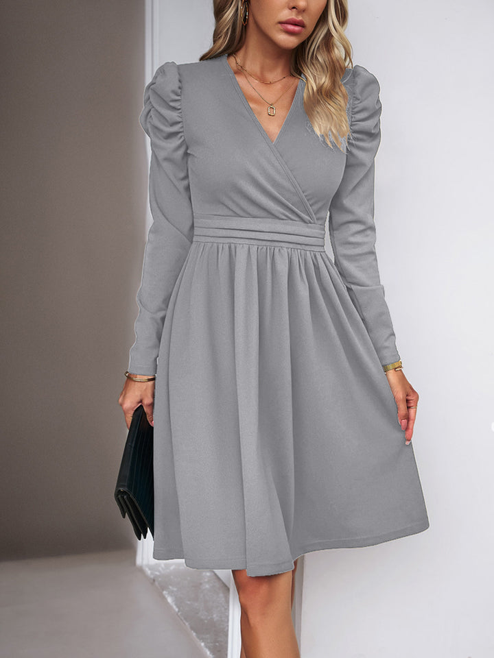 Women's wrap dress with V-neck, gathered puff sleeves, and fitted pleated skirt Drune