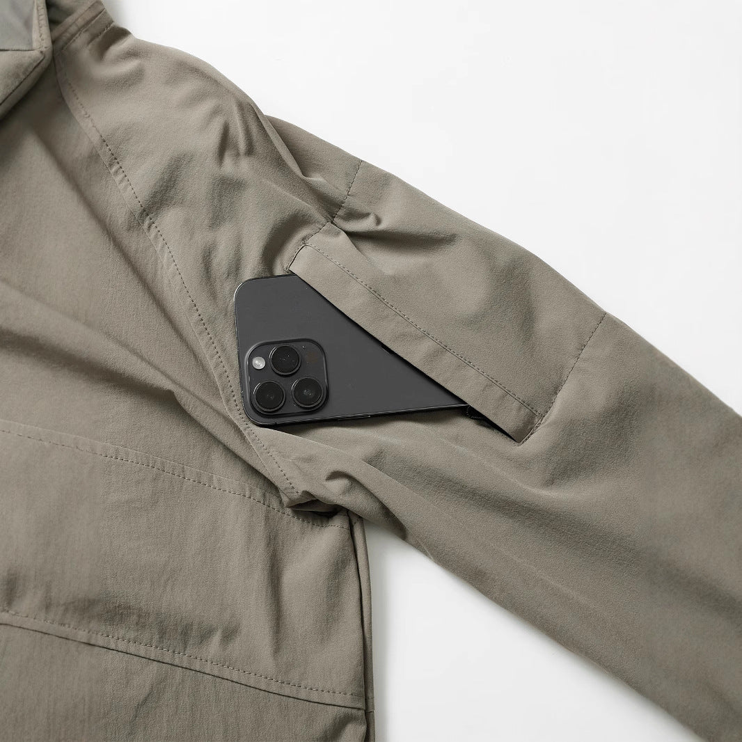 Men's lightweight tactical zip pullover with high collar, shoulder flaps, and concealed zip pockets.