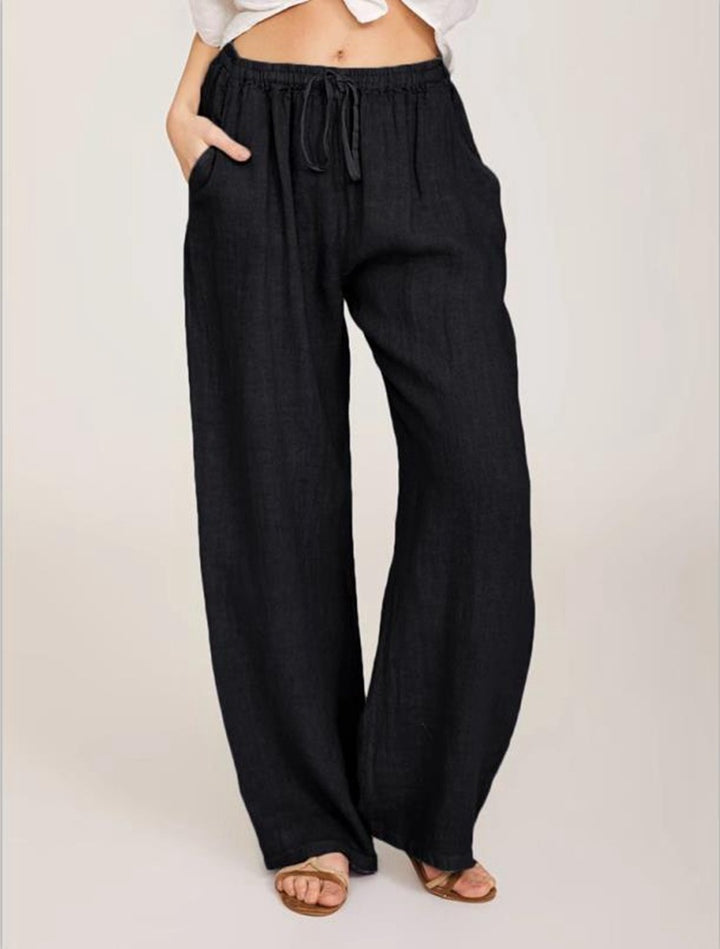 Women's airy palazzo pants with drawstring waistband, elastic waist finish, and side pockets Mune Fashion