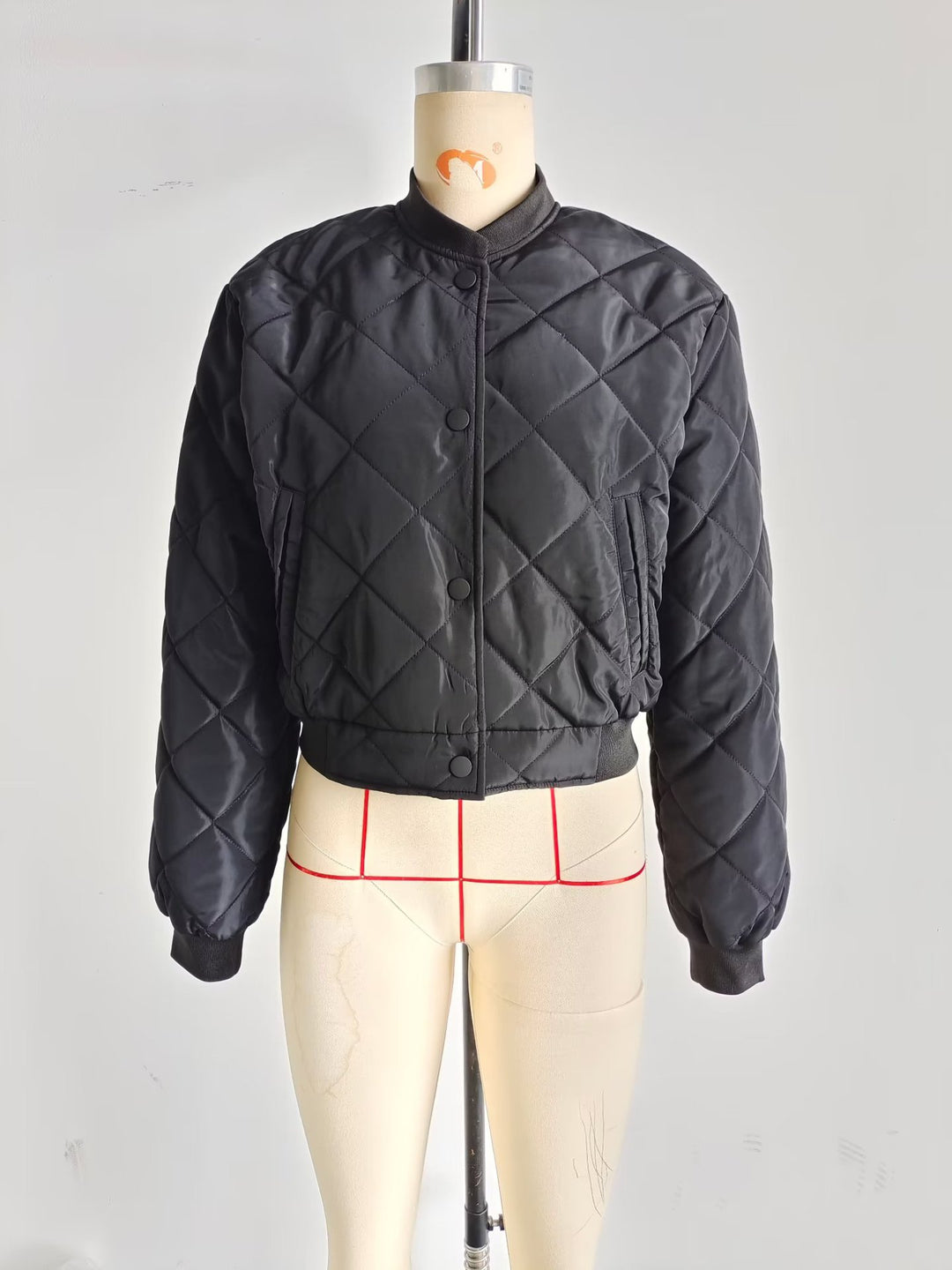 Women's quilted bomber jacket with diamond quilting, ribbed cuffs, and concealed snap button placket Mune Fashion
