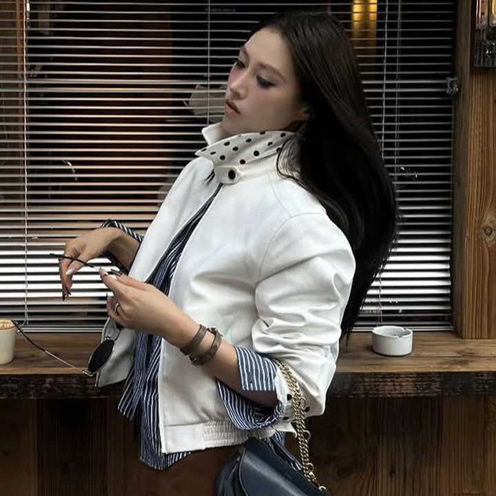 Women’s short-cut blouson jacket with stand-up collar, concealed zipper and contrasting polka dot patterned lining Mune Fashion