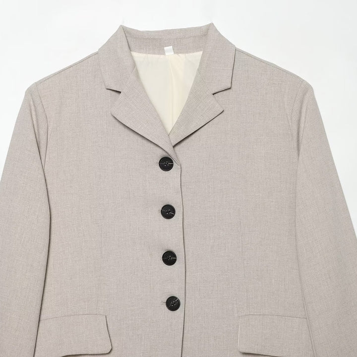 Women's short blazer with minimalist lines, rounded hem, and flap pockets Mune Fashion