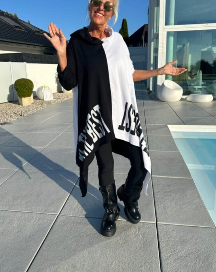 Women’s long-cut hooded poncho with asymmetric pointed hem and large statement print Mune Fashion