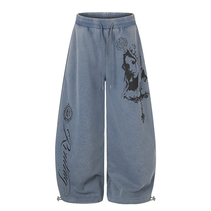 Women's extra-wide palazzo harem pants made of sweatshirt fabric with a high comfort waistband, drawstring, and large graphic print Mune Fashion
