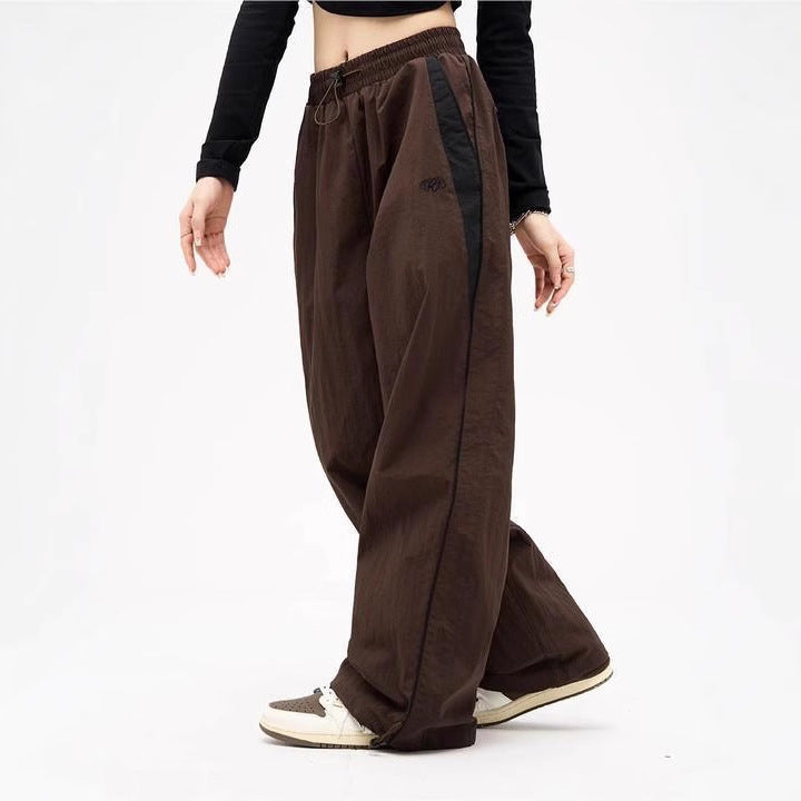 Women's wide track pants with contrast piping, elastic waistband and oversized fit Mune Fashion