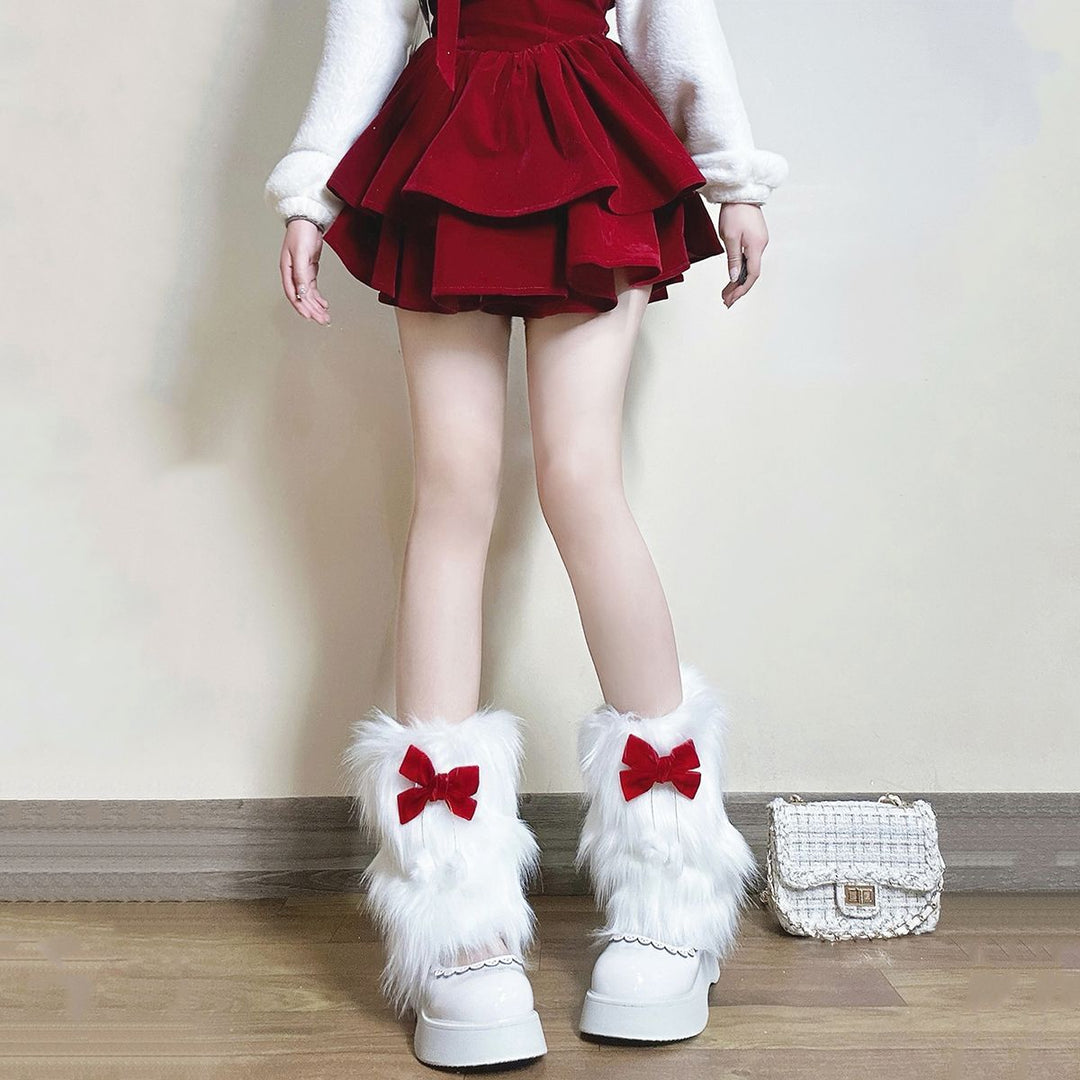 Ladies cozy boot cuffs made of faux fur with bow appliqué and pompons Mune Fashion