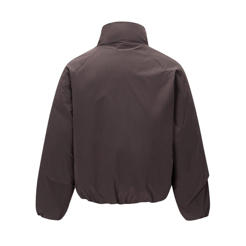 Unisex Short cut lightweight windbreaker in boxy cut with high stand-up collar and elastic hem Mune Fashion