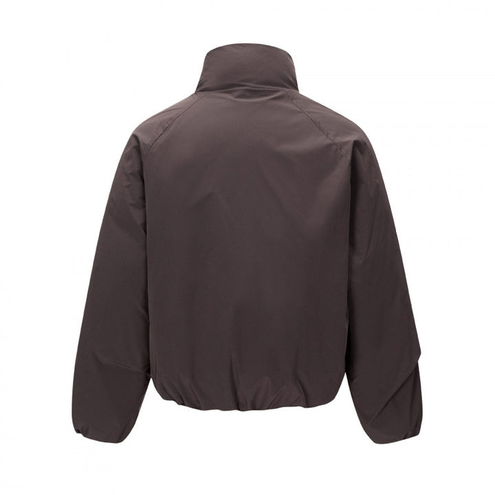 Unisex Short cut lightweight windbreaker in boxy cut with high stand-up collar and elastic hem Mune Fashion