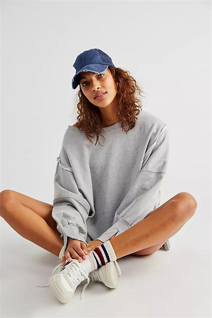 Women's oversized sweatshirt with balloon sleeves, open seam stitches, and side slits Mune Fashion