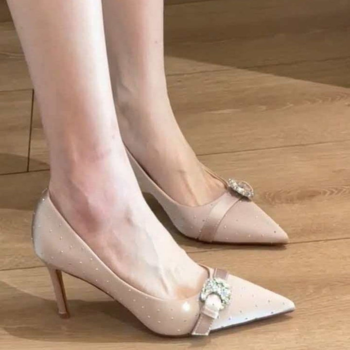 Ladies patent pumps with pointed toe, rhinestone buckle, and mid-high stiletto heel