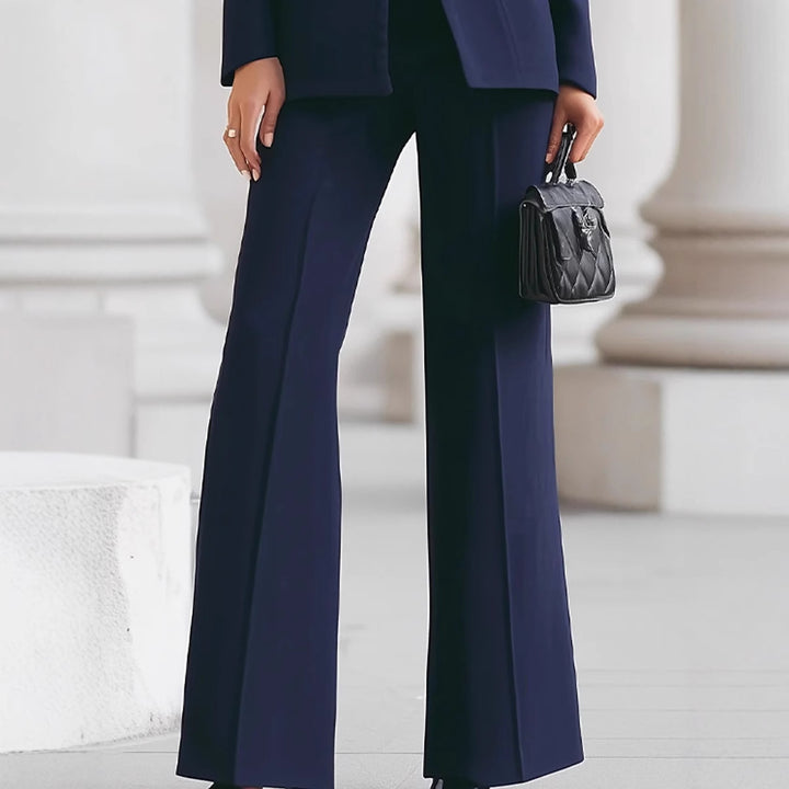 Women tailored suit with stand-up collar, fitted peplum and flared trousers Mune Fashion