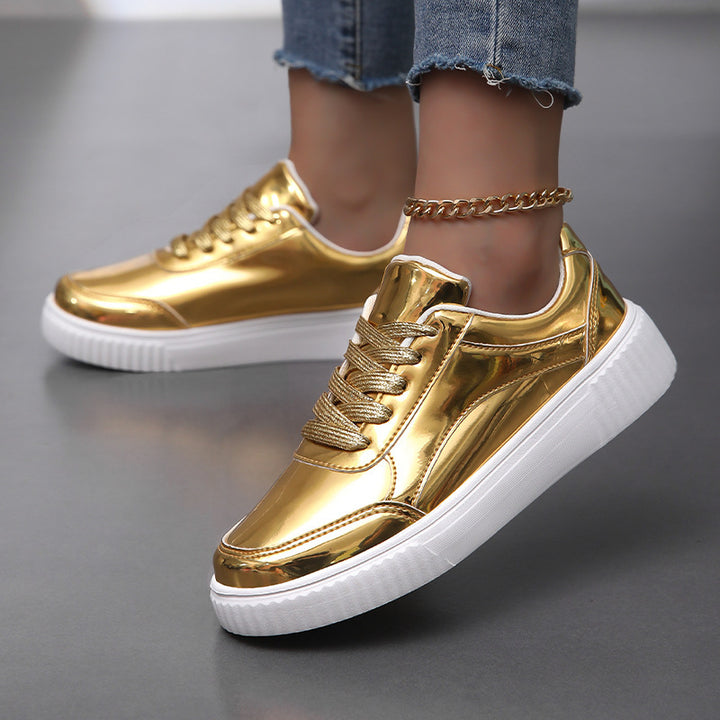 Ladies' low-cut sneakers with reflective patent upper, padded shaft, and raised outsole with groove profile Mune Fashion