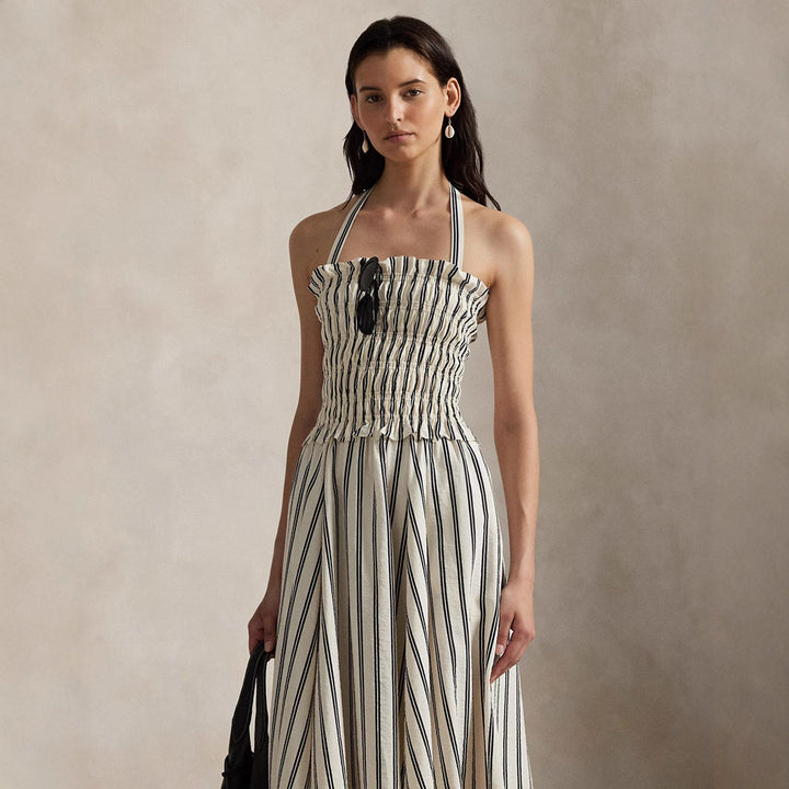 Women's midi dress with smocked bodice, adjustable halter strap, wide A-line skirt and side pockets Mune Fashion