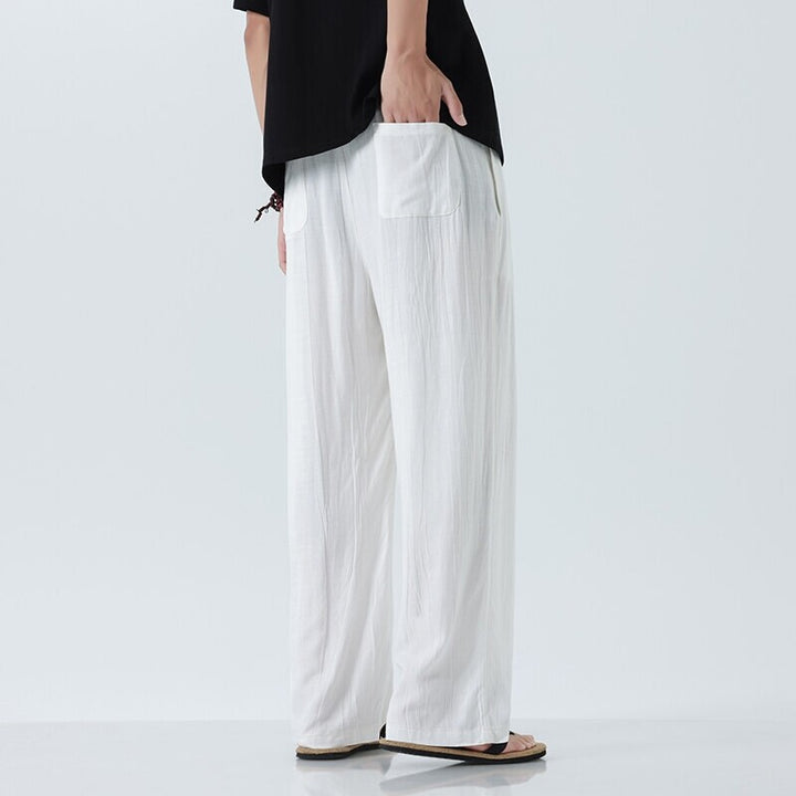 Men's loose linen trousers with adjustable drawstring waistband, casual pleat look, and side pockets Mune Fashion