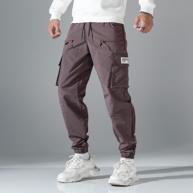 Men's tapered cut utility cargo pants in jogger style with drawstring waistband, zippered pockets & elastic leg cuffs Mune Fashion