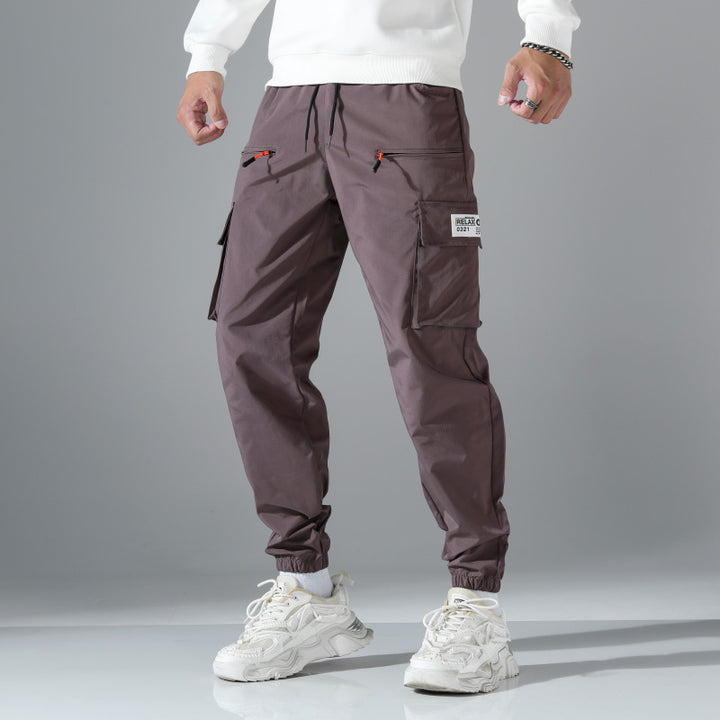 Men's tapered cut utility cargo pants in jogger style with drawstring waistband, zippered pockets & elastic leg cuffs Mune Fashion