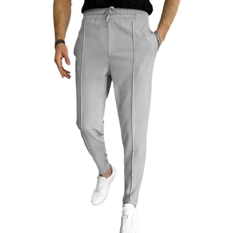 Men's patterned jogging pants with elastic drawstring, shaping crease, and tapered leg Mune Fashion