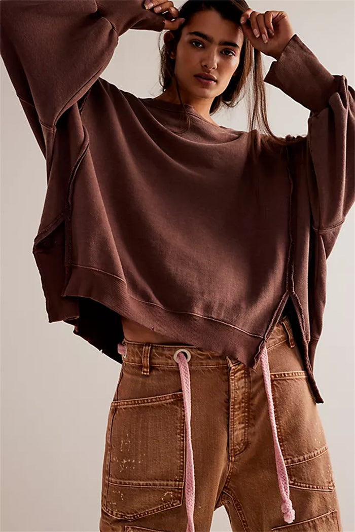Women's oversized sweatshirt with balloon sleeves, open seam stitches, and side slits Mune Fashion