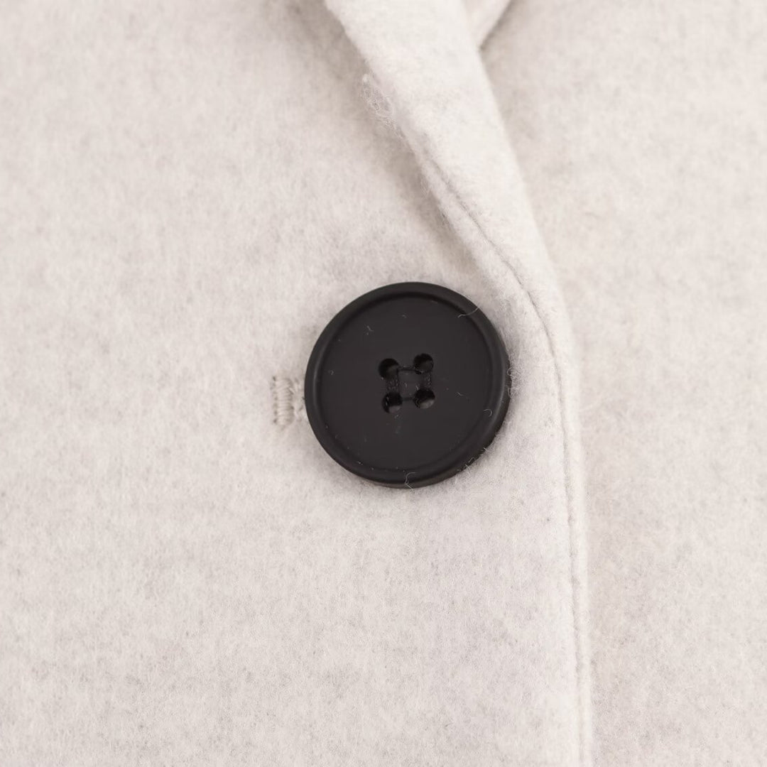 Ladies Purist longline coat with lapel collar, single button closure and soft felt finish Mune Fashion