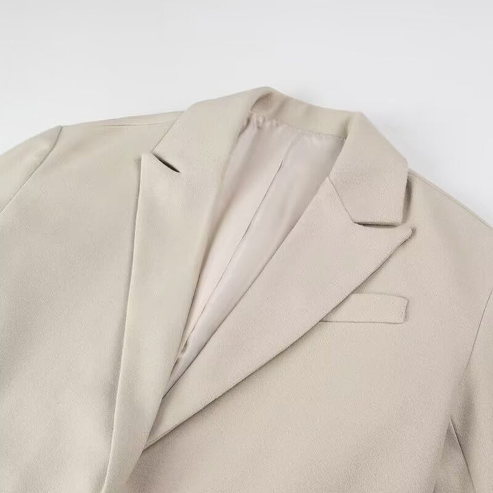 Women’s long coat with long fringe hem, boxy oversized silhouette, and lapel collar Mune Fashion