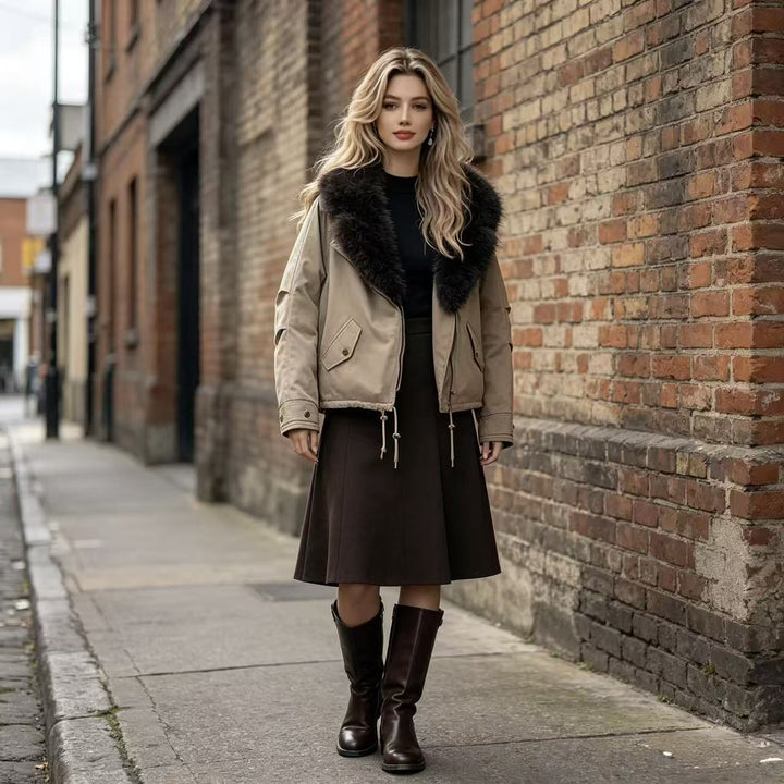 Women's short bomber jacket with voluminous faux fur collar, drawstring hem, and flap pockets Mune Fashion