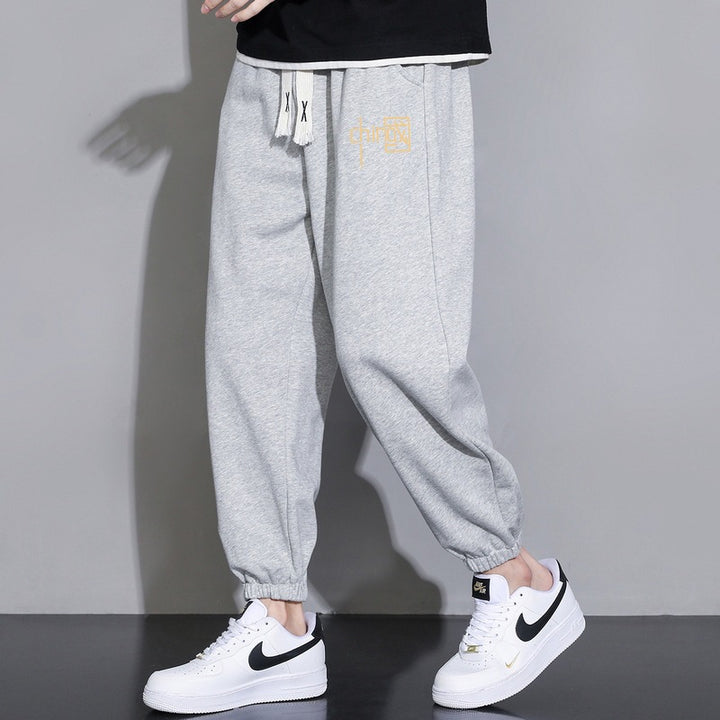 Men's loose fitting sweatpants with drawstring, elastic cuffs, and side pockets Mune Fashion
