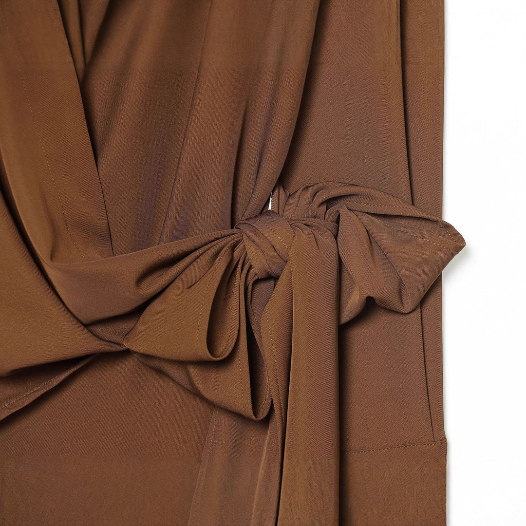 Women's flowing wrap blouse with wide lapel collar, dropped shoulder, and decorative side tie Mune Fashion