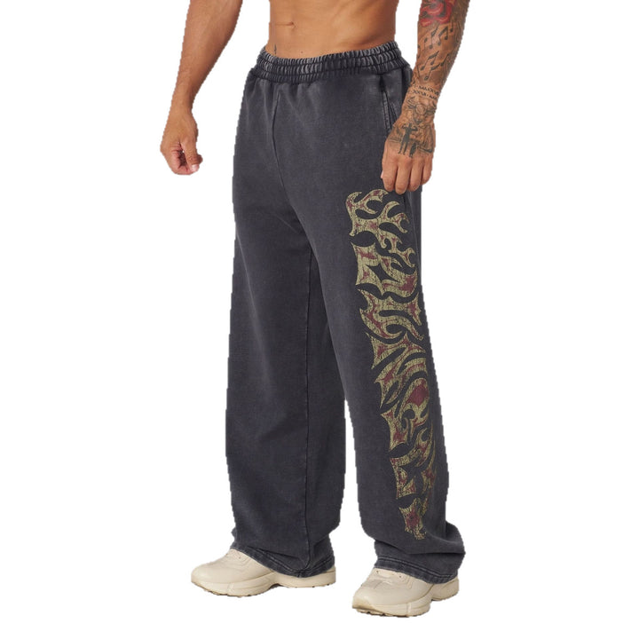 Men's baggy joggers with elastic waistband, side pockets and detailed skull and rose motif Mune Fashion