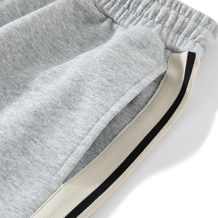 Men's loose-fitting joggers with elastic waistband, drawstring, and contrasting side stripes Mune Fashion