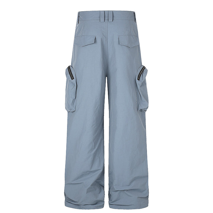 Women wide-cut cargo palazzo pants with high waist, zip pockets and layered panels Mune Fashion