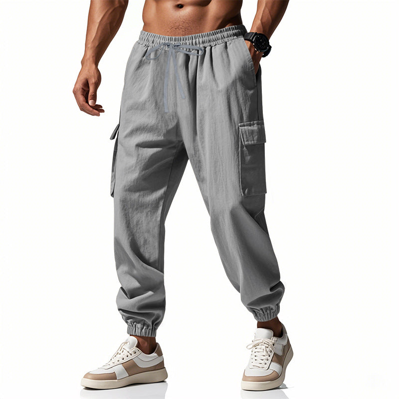 Men's tapered joggers in utilitarian style with elastic waistband, drawstring, and flap pockets Mune Fashion