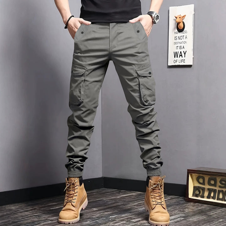 Men's cargo jogger pants with elastic waistband, drawstring, and multifunctional pockets.